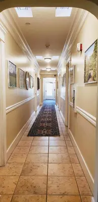 a hallway in a building with a tile floor at Santa Paula Inn in Santa Paula