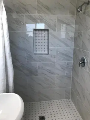a bathroom with a white toilet and a shower at Desert Inn in Mojave