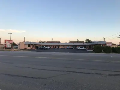 an empty street in front of a motel at Desert Inn in Mojave