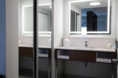 a bathroom with two sinks and two mirrors at Hampton Inn & Suites Sherman Oaks in Sherman Oaks