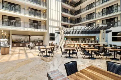 an empty lobby of a hotel with tables and chairs at Embassy Suites by Hilton Los Angeles International Airport South in El Segundo