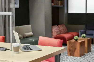 an office with a desk with a laptop computer on it at Embassy Suites by Hilton Los Angeles Downey in Downey