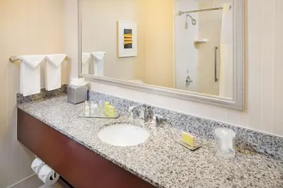 a bathroom with a sink and a mirror at DoubleTree by Hilton Los Angeles/Commerce in Commerce