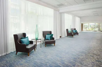 a waiting room with chairs and a vase on a table at DoubleTree by Hilton Los Angeles/Commerce in Commerce