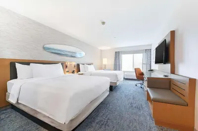 a hotel room with two beds and a flat screen tv at Hilton Garden Inn LAX - El Segundo in El Segundo