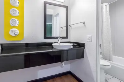 a bathroom with a sink and a mirror at Motel 6 Riverside, CA - UCR East in Riverside