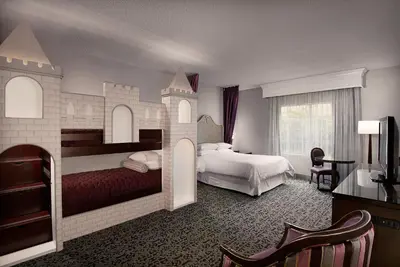 a room with a castle bedroom with two beds at Anaheim Majestic Garden Hotel in Anaheim