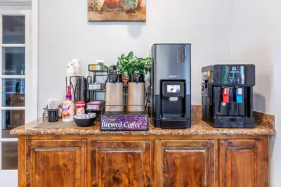 a counter with a coffee maker and a coffeemaker on it at Best Western Plus Hill House in Bakersfield