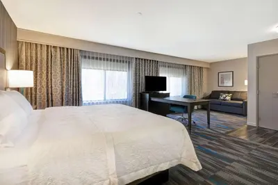 a hotel room with a large bed and a desk at Hampton Inn & Suites Los Angeles Burbank Airport in Burbank