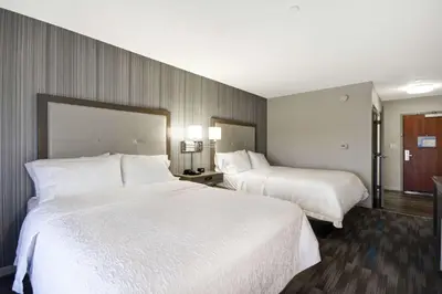a hotel room with two beds with white sheets at Hampton Inn & Suites Los Angeles Burbank Airport in Burbank