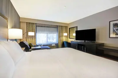a hotel room with a large bed and a flat screen tv at Hampton Inn & Suites Los Angeles Burbank Airport in Burbank
