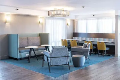a lobby with chairs and tables and a waiting room at Hampton Inn Los Angeles Santa Clarita in Santa Clarita