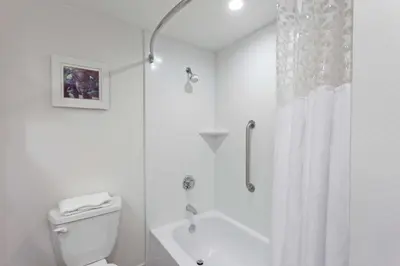 a white bathroom with a shower and a toilet at Hampton Inn Los Angeles/Arcadia in Arcadia