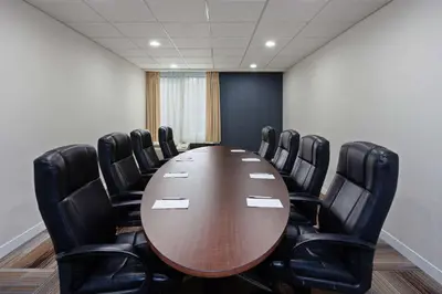 a conference room with a wooden table and black chairs at Hampton Inn Los Angeles/Arcadia in Arcadia