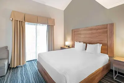 a hotel room with a large bed and a window at Best Western Posada Royale Hotel & Suites in Simi Valley