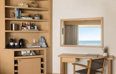a room with a desk and a mirror and a table at Malibu Beach Inn in Malibu