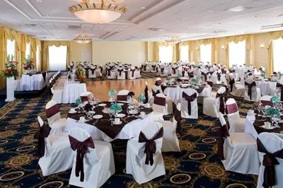 a banquet hall filled with tables and chairs at Knott's Hotel in Buena Park