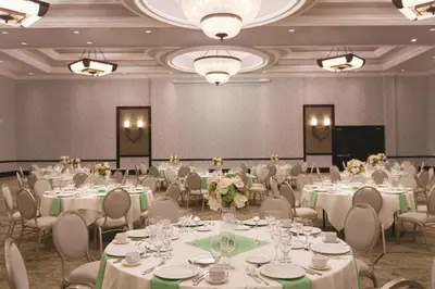 a banquet hall with white tables and chairs at Hilton Los Angeles/San Gabriel in San Gabriel
