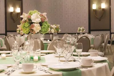 a table with a vase of flowers on it at Hilton Los Angeles/San Gabriel in San Gabriel