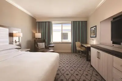 a hotel room with a bed and a desk at Hilton Los Angeles/San Gabriel in San Gabriel