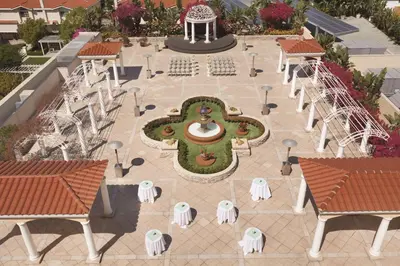 an overhead view of a courtyard with a fountain and tables and chairs at Hilton Los Angeles/San Gabriel in San Gabriel