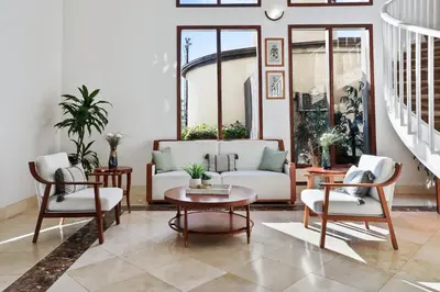 a living room with a couch and chairs and a table at Brookhurst Plaza Inn in Anaheim