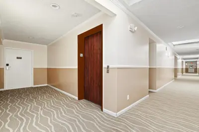 an empty room with a door and a hallway at Brookhurst Plaza Inn in Anaheim