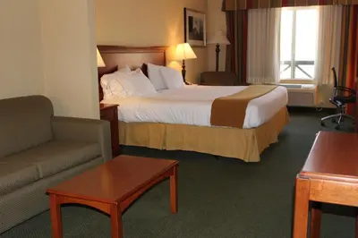 a hotel room with a bed and a couch at Holiday Inn Express Tehachapi by IHG in Tehachapi