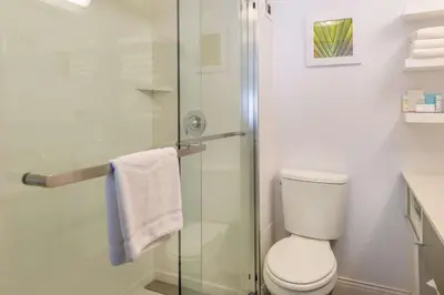 a bathroom with a toilet and a glass shower at Hampton Inn Los Angeles-West Covina in West Covina