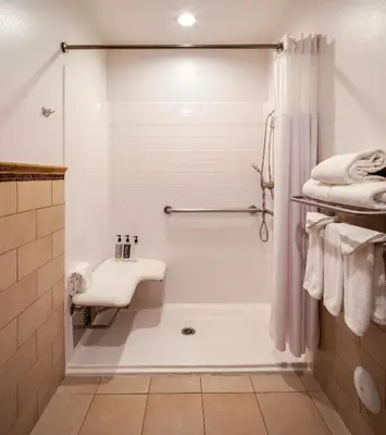 a white bathroom with a shower and a sink at Ayres Hotel Chino Hills Ontario in Chino Hills