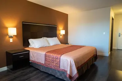 a hotel room with a large bed with two pillows at Maywood Inn in Maywood