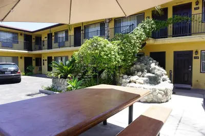 a wooden table sitting in front of a building at Casa Bella Inn Downtown LA in Los Angeles