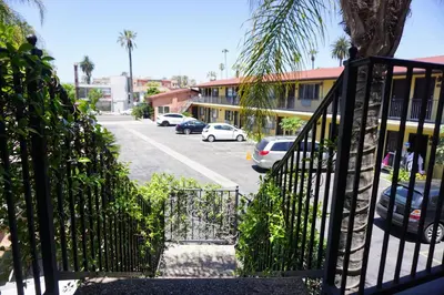 a stairway leading to a parking lot with cars parked at Casa Bella Inn Downtown LA in Los Angeles