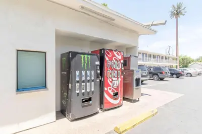 two vending machines sitting outside of a building at Motel 6 Bakersfield in Bakersfield