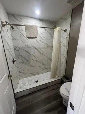 a bathroom with a shower and a toilet at Eastsider Motel -Downtown LA New Rooms in Los Angeles