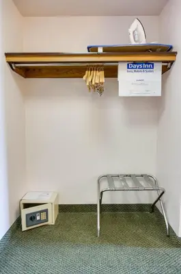 a shelf on a wall with a bench and a scale at Days Inn & Suites by Wyndham Fullerton in Fullerton