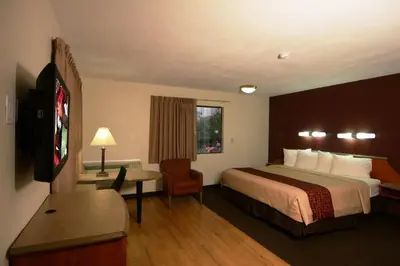 a hotel room with a large bed and a desk at Red Roof Inn San Dimas - Fairplex in San Dimas