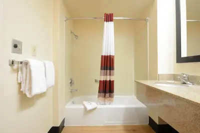 a bathroom with a tub and a shower and a sink at Red Roof Inn San Dimas - Fairplex in San Dimas