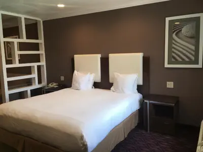 a bedroom with a large bed with white sheets and pillows at Hotel Pacific, Manhattan Beach in Manhattan Beach