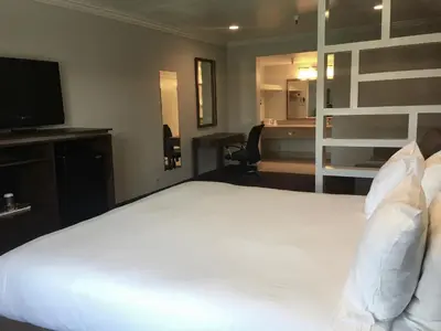 a bedroom with a large white bed and a desk at Hotel Pacific, Manhattan Beach in Manhattan Beach