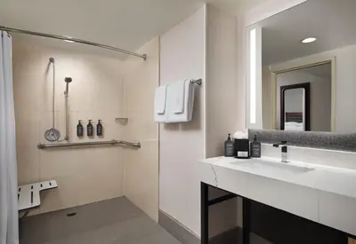 a bathroom with a sink and a mirror at Sheraton Ontario Airport Hotel in Ontario