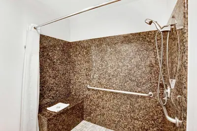 a bathroom with a shower with a toilet at Super 8 by Wyndham Cypress Buena Park Area in Cypress