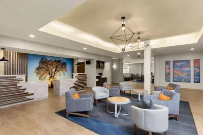 a lobby with chairs and tables and a waiting room at La Quinta by Wyndham Santa Clarita - Valencia in Stevenson Ranch