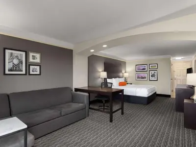 a hotel room with a bed and a couch at La Quinta by Wyndham Santa Clarita - Valencia in Stevenson Ranch
