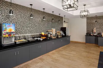 a cafe with a counter with food on it at La Quinta by Wyndham Santa Clarita - Valencia in Stevenson Ranch