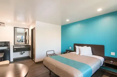 a hotel room with a bed and a sink and a table at Motel 6-South El Monte, CA - Los Angeles in South El Monte