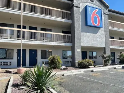 a building with a sign on the side of it at Motel 6 Barstow, CA - Lenwood Road in Barstow
