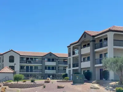 a large apartment building with a courtyard in front at Motel 6 Barstow, CA - Lenwood Road in Barstow