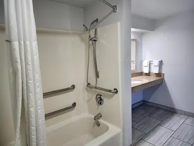 a bathroom with a shower and a tub and a sink at Motel 6 Barstow, CA - Lenwood Road in Barstow