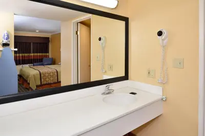 a bathroom with a sink and a mirror at Americas Best Value Inn - Azusa/Pasadena in Azusa